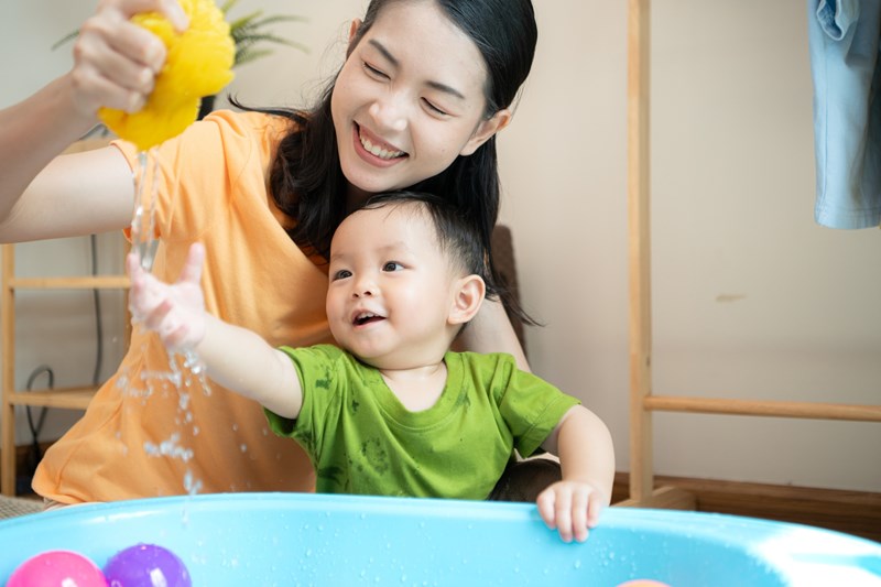Mom and little child with taking a shower and dressing at home