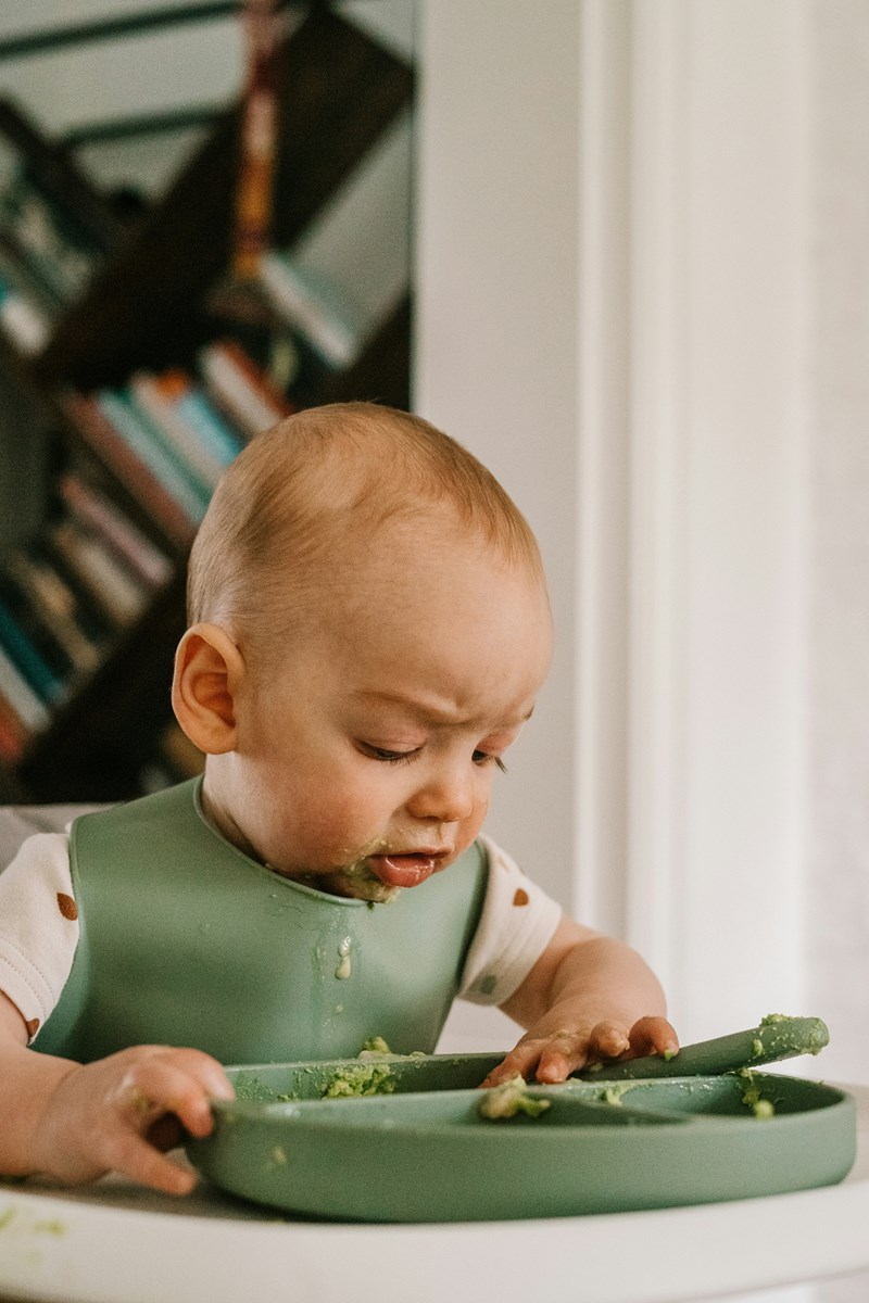 Baby eating using fingers